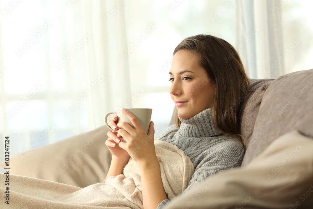 Tenant resting holding coffee on a couch Tenant resting holding coffee on a couch