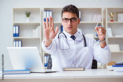 Wallpaper Mural Male doctor in anti-smoking conceptwithcigarette pack Torontodigital.ca