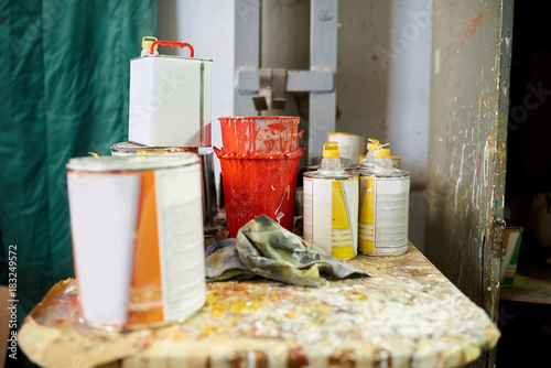Cans of paint. Red, yellow and orange paint.