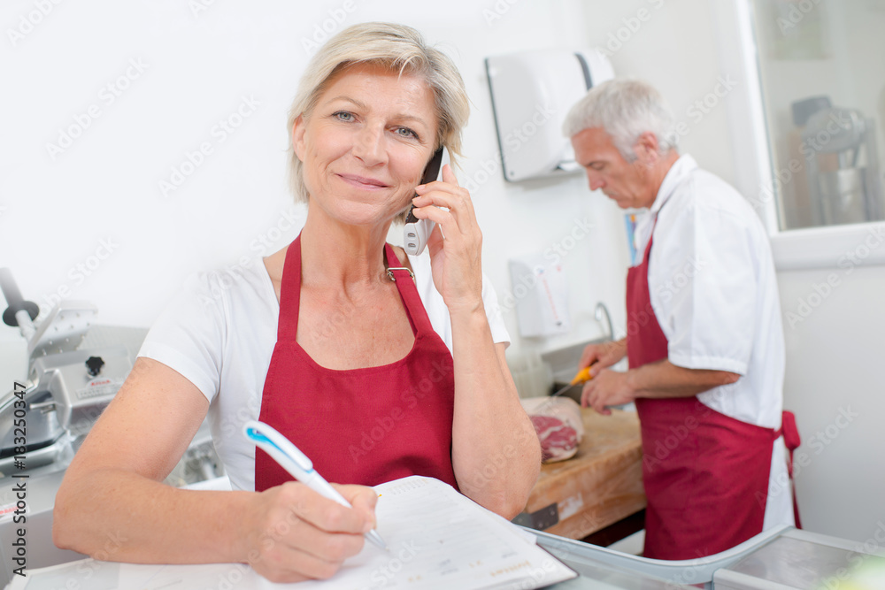 Fototapeta premium Butcher owner telephone