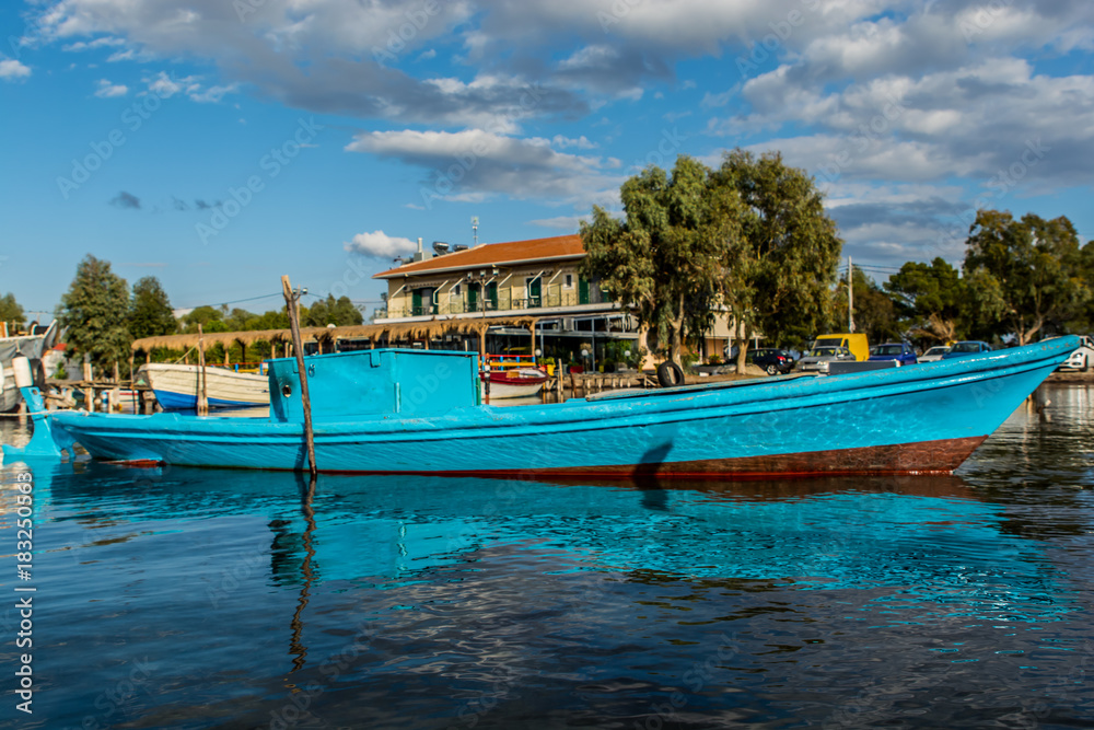 A small blue fishing boat