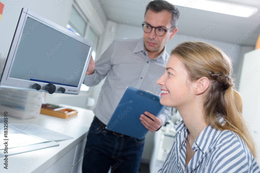 physician instructing the patient to look at the screen physician instructing the patient to look at the screen