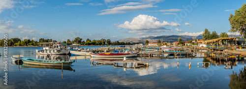 Panorama of the pier of fishing boats in Tourlida, Mesologi on a colorful cloudy day, Greece