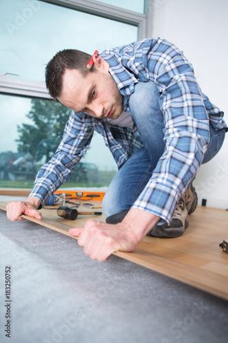 man working on wood floor