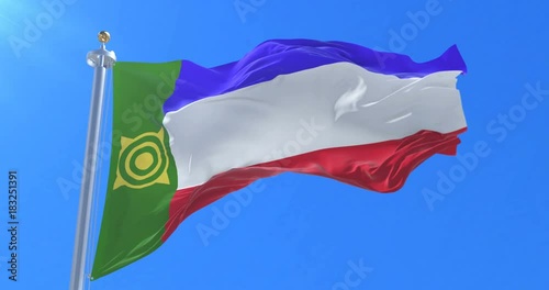 Flag of Khakassia waving at wind with blue sky in slow, loop photo