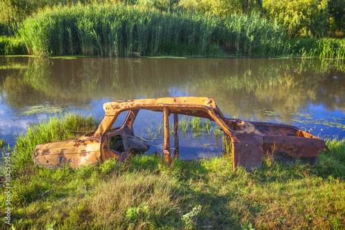 abandoned old car in water