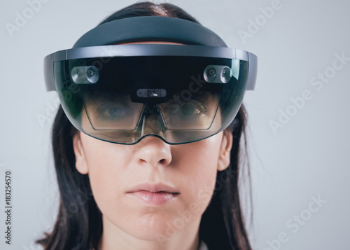 Woman wearing augmented reality goggles. © romaset