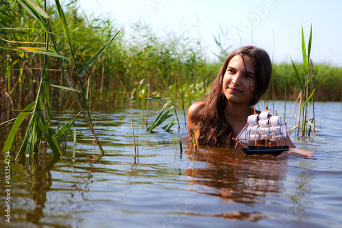 Fototapeta Naklejka Na Ścianę i Meble -  The girl and the boat