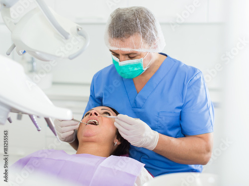 adult dentist checking teeth