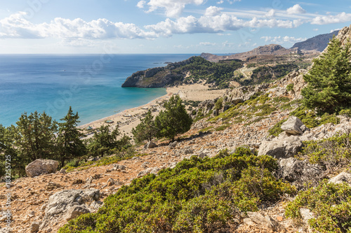 Stony landscape and a view of the Tsambika beach on the Rhodes Island, Greece