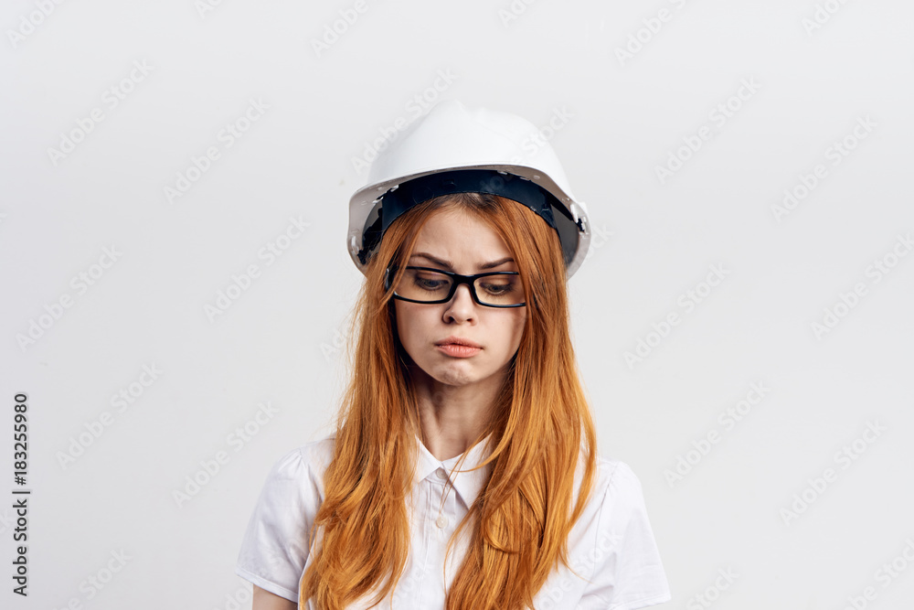 red-haired woman in helmet on light background red-haired woman in helmet on light background