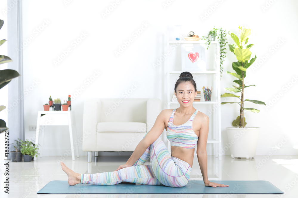 Asian beautiful sports woman performs the exercises at home . Asian beautiful sports woman performs the exercises at home .