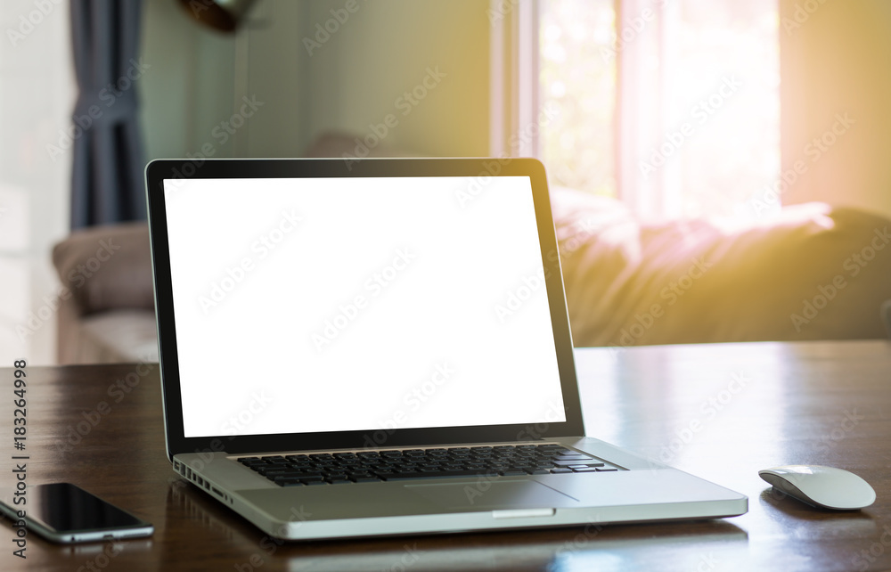 Blank white screen laptop computer on wood table with sunlight effected Blank white screen laptop computer on wood table with sunlight effected