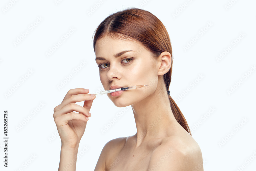 a woman holding a syringe in her mouth, plastic surgery a woman holding a syringe in her mouth, plastic surgery