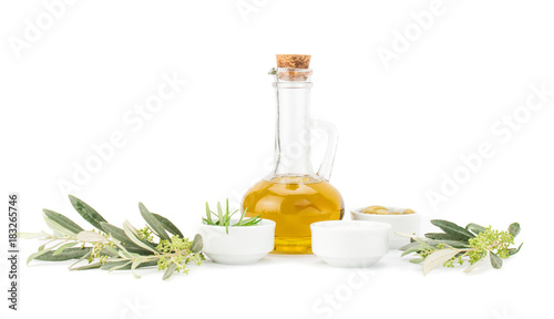 Glass bottle of premium virgin olive oil, lemon and some olives with olive branch isolated on a white background.