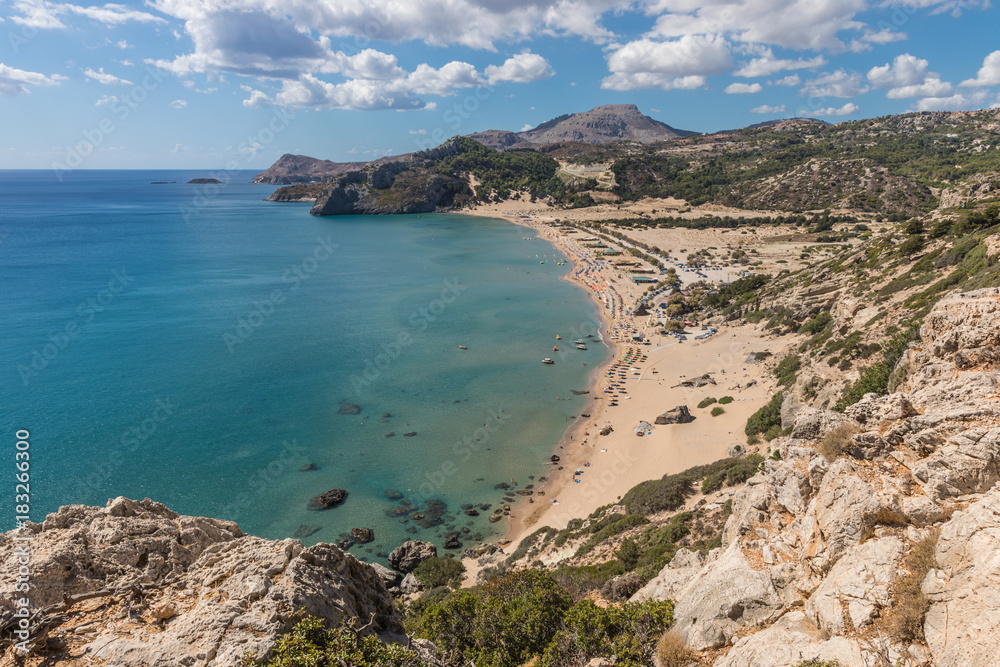 Stony landscape and a view of the Tsambika beach on the Rhodes Island, Greece