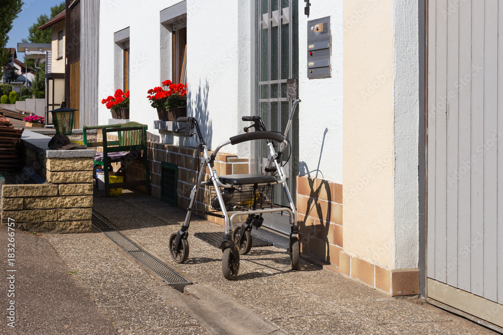 rollator in front of house door on a hot july summer day