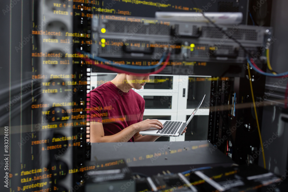 custom made wallpaper toronto digitalPortrait of modern young man holding laptop standing in server room working with supercomputer