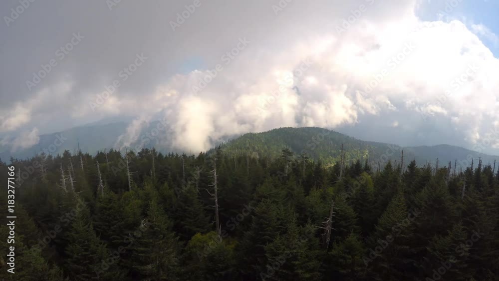 Great Smoky Mountains National Park's highest point Clingman's Dome with dramatic clouds sweeping mountains peaks in summer Great Smoky Mountains National Park's highest point Clingman's Dome with dramatic clouds sweeping mountains peaks in summer