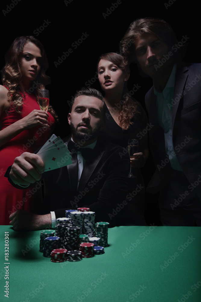concentrated men and women playing poker in casino concentrated men and women playing poker in casino