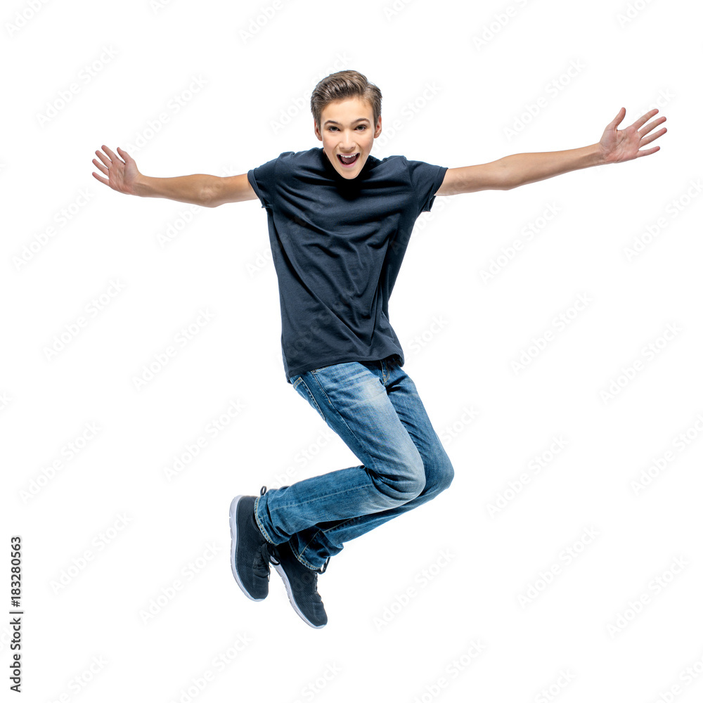 Photo of happy teenage boy jumping with hands up Photo of happy teenage boy jumping with hands up