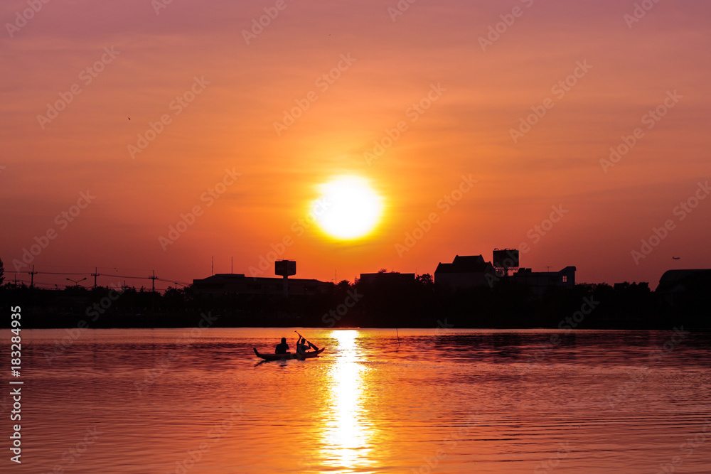 Rowing kayak in sunset
