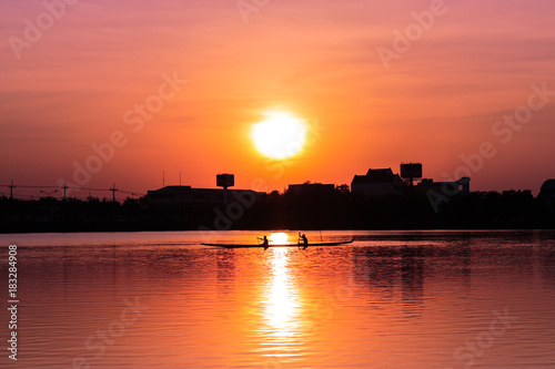 Rowing kayak in sunset