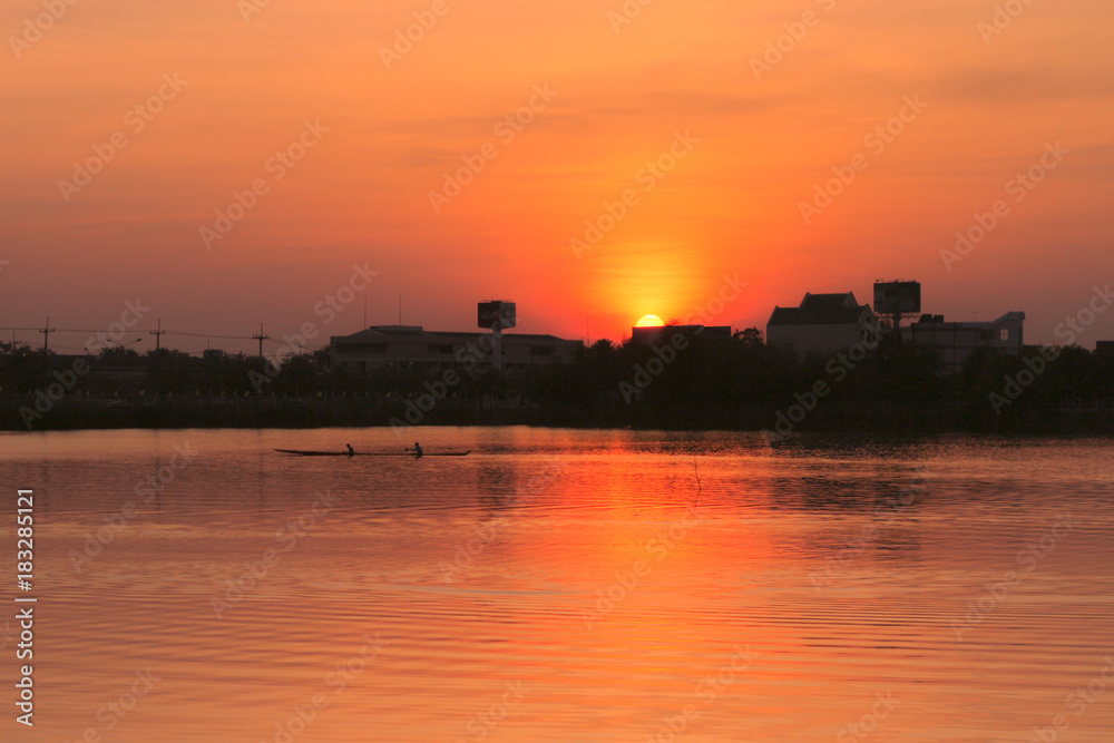 Rowing kayak in sunset