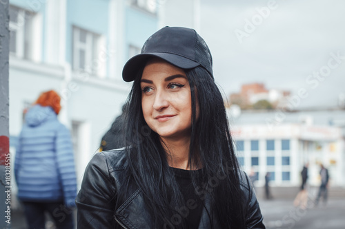 Beautiful brunette girl in black cap photo