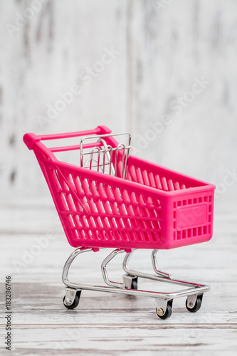 Miniature Pink Toy Shopping Cart on White Background