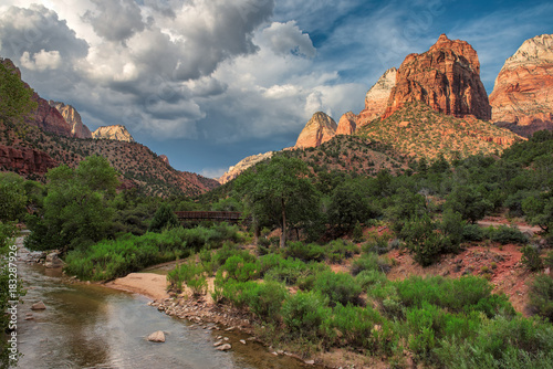 Sunset over red cliffs and Virgin river at Zion National Park, Utah, USA.