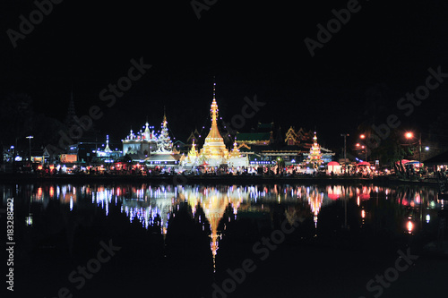 Beautiful View of Wat Jong Klang in dark night and reflection at Maehongson  province North of Thailand. Asia. De-focus
