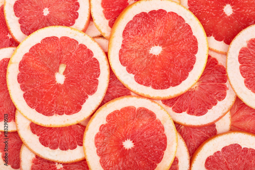 Grapefruit slices as background. Top view. Flat lay pattern
