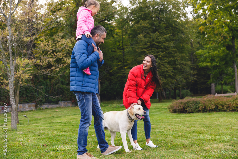 Fototapeta premium Happy young parents with adorable little daughter