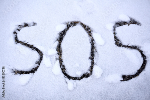 SOS sign for help needed written in the snow