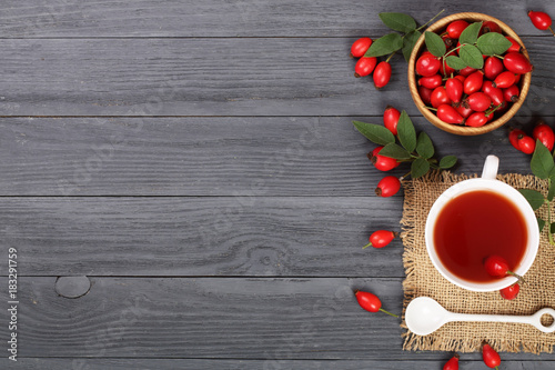 tea with rose hips and honey on a black wooden background with copy space for your text. Top view