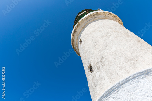 A white lighthouse  in The Prasonisi National Park on the  southern end of Rhodes in Greece  photo