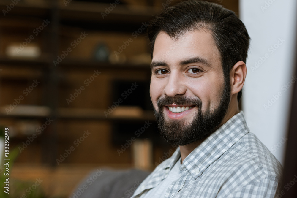 young smiling attractive man with beard looking at camera young smiling attractive man with beard looking at camera