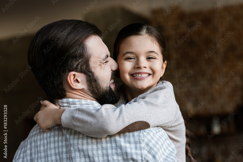 Cheerful Father And Daughter Hugging And Looking At Camera At Home