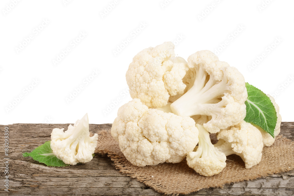 Piece of cauliflower on wooden table with white background Piece of cauliflower on wooden table with white background