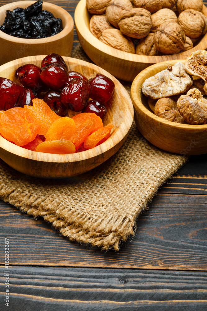 dried fruits figs, apricots, plums and nuts on wooden background dried fruits figs, apricots, plums and nuts on wooden background