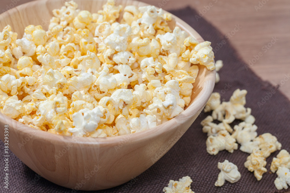 popcorn in wooden bowl popcorn in wooden bowl