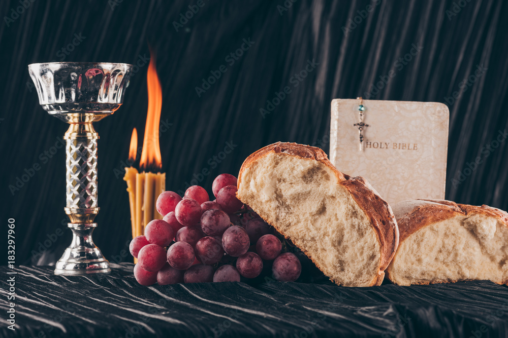 bread, bible, chalice and christian cross on black table, Holy Communion