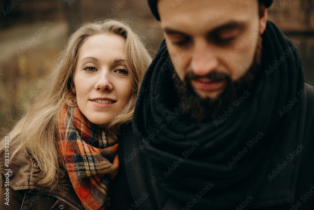 Young hipster couple hugging each other in autumn park.Winter love story, a beautiful stylish young couple. Fashion concept with boyfriend and girlfriend Young hipster couple hugging each other in autumn park.Winter love story, a beautiful stylish young couple. Fashion concept with boyfriend and girlfriend
