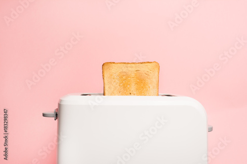 Healthy fashion food of breakfast. Toast in a toaster on a pink background.