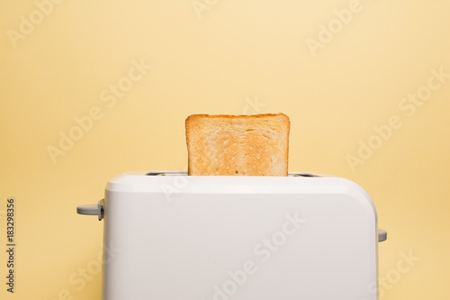 Healthy fashion food of breakfast. Toast in a toaster on a yellow background.