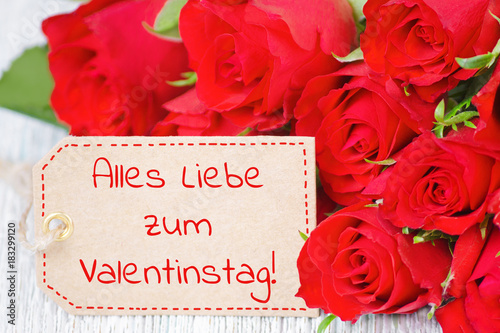 label with german text happy valentines day and red rose flowers
