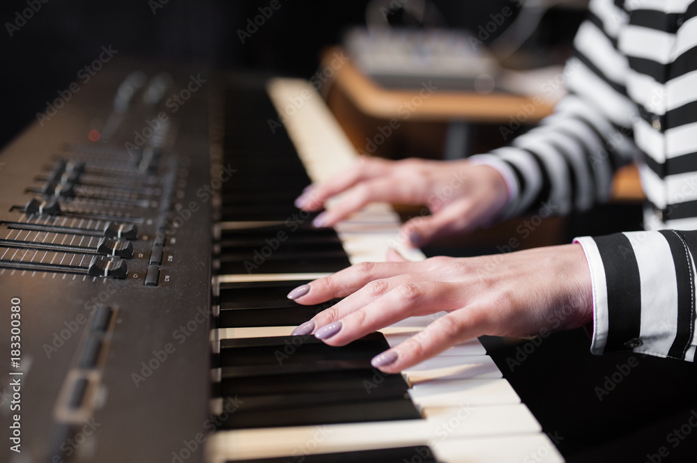 Fototapeta premium the girl is playing the piano.