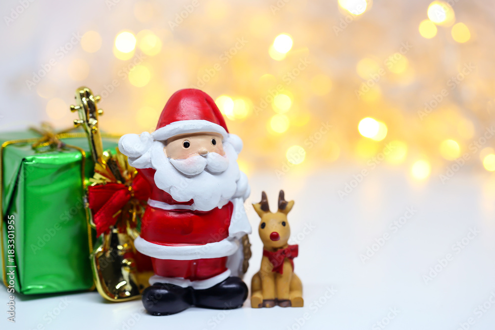 Fototapeta premium Santa Claus doll on bokeh background for celebration Christmas Eve.Happy New Year