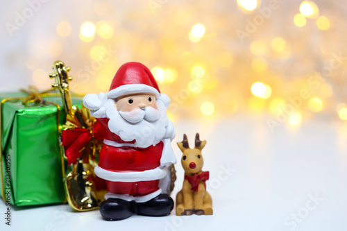 Santa Claus doll on bokeh background for celebration Christmas Eve.Happy New Year